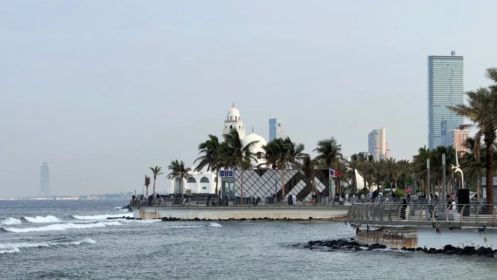 Jeddah Corniche in the morning with palm trees and waves breaking on the rocks