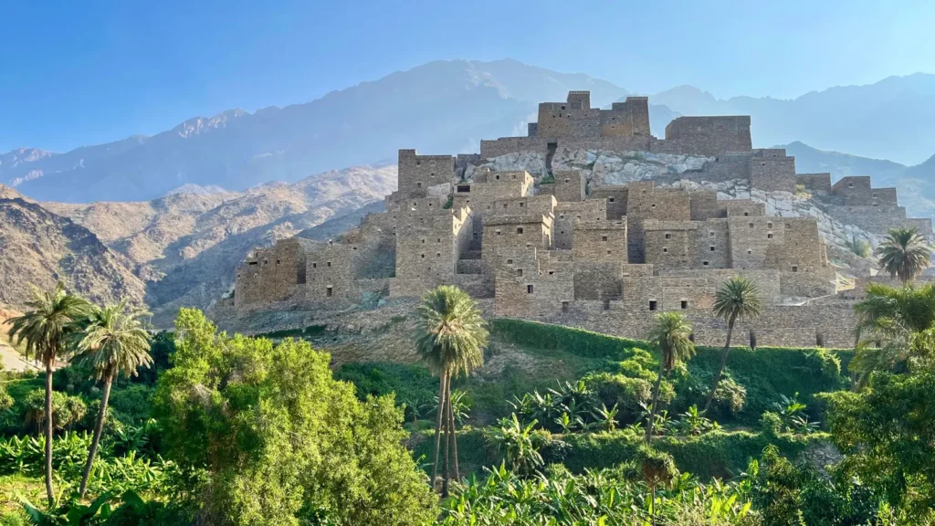 Antigua aldea de piedra sobre una cresta rocosa rodeada de árboles verdes en las montañas de Al Bahah, en la ruta de Taif a Al Baha por carretera